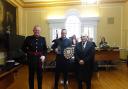 DL Chris Parkhouse presenting the shield to Luke Claxton, with Cllr Phil Pearce.