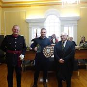 DL Chris Parkhouse presenting the shield to Luke Claxton, with Cllr Phil Pearce.
