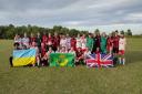 Huntingdon Town FC and Eunice Huntingdon FC, a mixed Polish and Ukrainian team, show their support after their 0-0 draw.