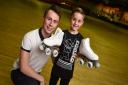 Colchester's Rollerworld head skating coach and 16 times Great British Champion Skater Chris Fox presents promising young skater Bailey Hobbs with new roller skates. Picture: GREGG BROWN