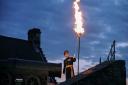 Major General Nick Eeles lights the beacon at Edinburgh Castle Credit for the Diamond Jubilee in 2012.