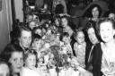 Children and family eating and celebrating during a Coronation party on East Street, St Neots, in 1953.