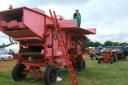 A Marshall threshing machine owned by Brian Spiers, of Wyboston. William Hickling is on top of the machine.