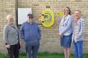 David Rolph and his sister Debbie Whitehead (L) have purchased a defibrillator for Somersham. They are pictured with Irene from Somersham Parish Council, and Debbie's Husband, Nigel Whitehead.