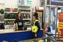 A PCSO talking to staff at The Factory Shop in Whittlesey