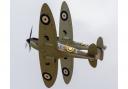 Two Supermarine Spitfires fly in formation.