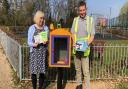 Little Paxton Parish Clerk Jenny Gellatly and Council Groundsman Mr Giles Buchanan with a revamped book swap box.