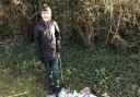 Elijah Hearn, 9, proudly showing off his impressive litter picking haul from the Co-op car park bushes in St Ives.
