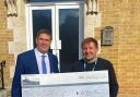 Tony Larkin hands over the cheque to Nick Burr, Sue Ryder's community fundraiser.
