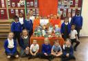 Pupils Fatma, Finley, Summer, Raymond, Logan, Frankie, Mattie, Reece, Millie, Lucy, James, Darcy, Oscar and Arabella with some of the harvest donations.