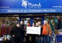 The memorial event organiser John Tompkins handed over a cheque to Sue Reeves, the manager of the MIND charity shop in Huntingdon, on February 1.