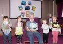 Resident Guy Grimley and the children from Meadow Lane Children's Nursery enjoyed reading a number of books together, including The Snail and the Whale.