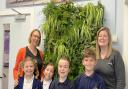 (From L to R) teacher Liz Harman, Izzy, Eva, Alex & Noah from the Eco Council and Emma Cohen from Trime UK with the 'Living Wall' situated in the foyer of the primary school.