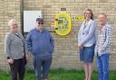 David Rolph and his sister Debbie Whitehead (L) have purchased a defibrillator for Somersham. They are pictured with Irene from Somersham Parish Council, and Debbie's Husband, Nigel Whitehead.