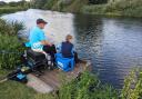 A young angler is introduced to fishing on the Great Ouse by the St Ives Fish Preservation and Angling Society.