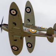 Two Supermarine Spitfires fly in formation.