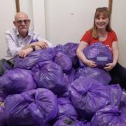 Kim Smith (left) and Kathie Reilly (right) with the donated bag of clothes used to raise money for Cancer Research UK.