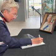 Mrs Julie Spence OBE QPM, the Lord Lieutenant of Cambridgeshire, signing a book of condolence after the death of HM Queen Elizabeth II.