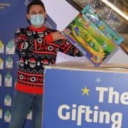 Josh Lovatt places the first gift in The Gifting Tree box this Christmas