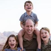 A smiling William is shown with his arms around Prince George, eight, and Princess Charlotte, seven, while four-year-old Prince Louis sits on his shoulders. The Duke and Duchess of Cambridge will be at County Day, Newmarket, on June 23.