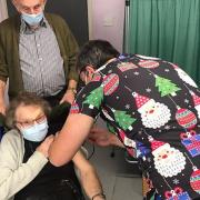 Cambridgeshire has seen its average Covid-19 vaccine uptake for all three doses dip below the national average. Pictured is Gladys Hatley being vaccinated by Dr Richard Brixey as Soham GP practice administered its first Covid vaccine, reported in 2021.