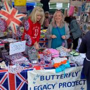 Butterfly Legacy Project volunteers selling Jubilee themed goods from their stall at St Ives market.