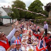 Residents of Murrayfield Drive in Edinburgh, sitting down to a previous Jubilee street party. Street parties in Huntingdonshire will start from today.
