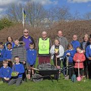 Members of Huntingdon and Huntingdon Cromwell Rotary clubs help the children of St Johns primary school plant 165 saplings.