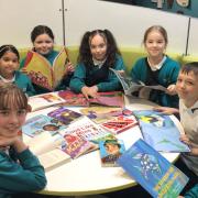 Pupils at Huntingdon Primary School read some of the new books, brought thanks to a large donation.