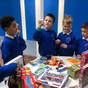 Children in year one of Middlefield Primary Academy swap toys with one another as part of the schools \'Green Day\'.