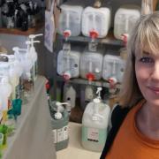 Seona Gunn-Kelly pictured in her shop in St Ives in front of the 20-litre containers used for refills.