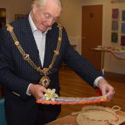 Mayor of Godmanchester Cllr Cliff Thomas looks at crafts from the Philippines at the Rehoboth 40th anniversary celebrations