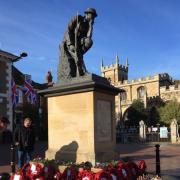 Thinking Soldier memorial covered with wreaths following Huntingdon\'s service of remembrance