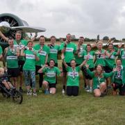 Riverside Runners pose by an airplane after the inaugural running of the Little Gransden 10k.