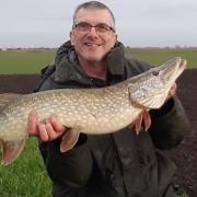 Mick Bartlett with his pike caught on a Fenland drain.
