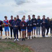 Members of Huntingdon Boat Club with their medals and trophies from the Head of River 2022.