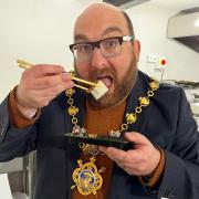 Mayor of Huntingdon, Cllr David Landon Cole tucks into some sushi at the Doge Sushi opening.
