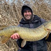 Mickey Bartlett of St Ives Tackle with a pike he caught.