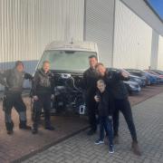 The team at AG Motors with the vandalised van at their repair shop in Cambridgeshire.