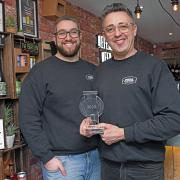Assistant Manager Ben Harradine (L) and the Filling Station's founder Matthew Kelly (R) with the Drinks Retailing Award in the store.