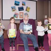 Resident Guy Grimley and the children from Meadow Lane Children's Nursery enjoyed reading a number of books together, including The Snail and the Whale.