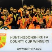 St Ives celebrate with the trophy after defeating Yaxley 3-1 on penalties to retain the Huntingdonshire FA County Cup final.