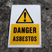 Stock image of an asbestos earning sign.