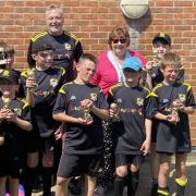The Pumas celebrated with their trophies in their new playing strips with coach John Salisbury and dreamdrops chairman Christine Luckham.