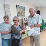 Diane Briars presented the joint winners cup toto Francisca  Shaw and Peter Walker.