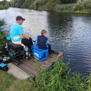 A young angler is introduced to fishing on the Great Ouse by the St Ives Fish Preservation and Angling Society.