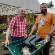 Vitalii Chornyi (right) collects his gardening supplies from Notcutts Brampton Garden Centre with Peter Menczer from the Brampton Village Hub. 