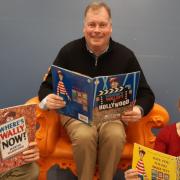 Cllr Tom Sanderson (centre) flanked by Cllr Michael Atkins (L) and Councillor Bryony Goodliffe (R) at Cambridge Central Library with copies of Where's Wally.