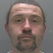 Patrick Muddiman has been jailed for brandishing a knife and assaulting a guest in his Huntingdon home with a glass Yankee candle.