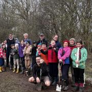 The Scouts, Cubs, Beavers and their parents and leaders planting trees for charity at Lake Ashmore.